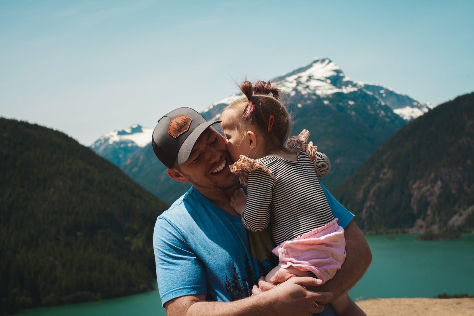 man carrying her daughter smiling