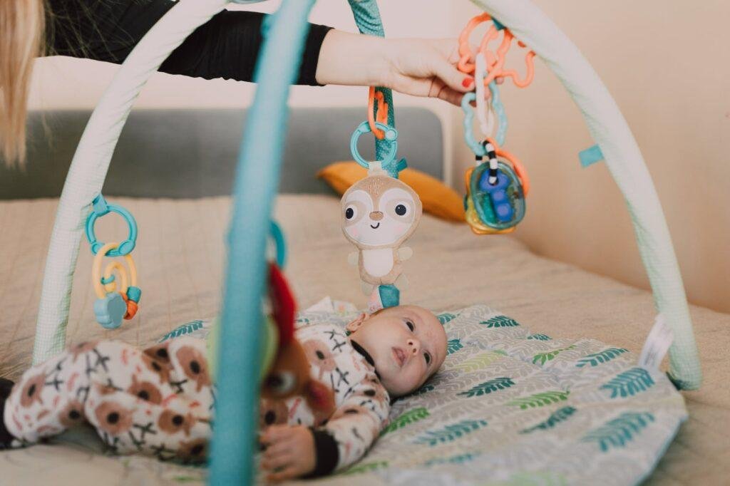 a baby lying on a baby play mat